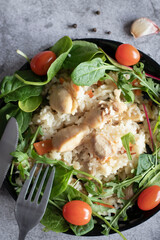 Rice pilaf with meat and vegetables. On a gray background
