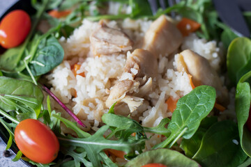 Rice pilaf with meat and vegetables. On a gray background