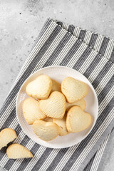 Lemon cookies. Lemon Heart cookies in a white plate on the light gray kitchen table. Cookies for Valentine's Day