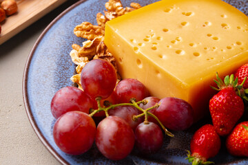 Cheese and grapes on plate close up