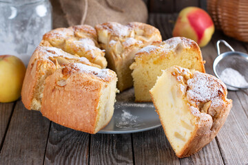 Homemade Soft and lite delicious sponge cake with ingredients: eggs, flour, apples on wood table