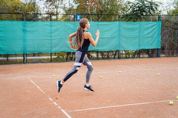 Obraz premium Qualitative warm-up. Warming up your muscles before an intense tennis workout on the court. Preparatory steps for an important tennis match. Sports exercises to help tone muscles