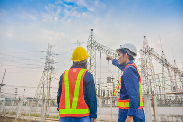 Asian Engineer Man and Women working on site power plant electric system to safety work