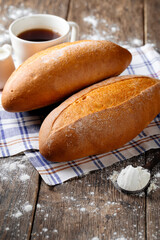Side view on loafs of yeast-free bread with coffee on the wooden cutting board