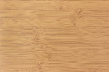 The texture of the smooth lacquered surface of the bamboo table.