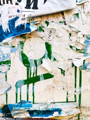 Layers of old colorful posters on wall damaged by time for your grunge style design