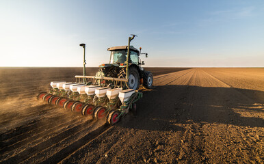 Farmer with tractor seeding