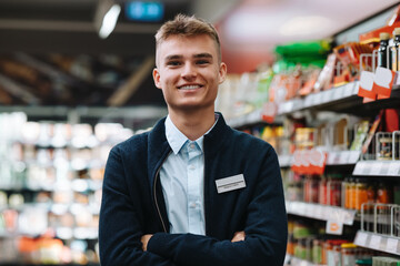 Fototapeta na wymiar Confident young supermarket worker