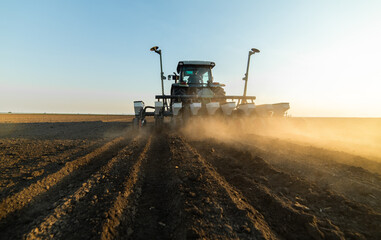 Fototapeta premium Farmer with tractor seeding