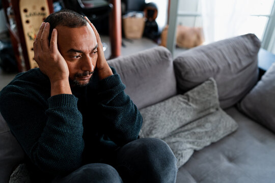 Sad 40 Years Old Man Sitting On The Sofa At Home