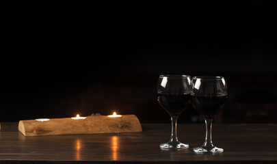 Glasses of red wine. Wooden candlestick and candles. St. Valentine's Day. Love