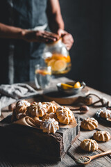 Man pours Hot tea with slices of fresh grapefruit on wooden tablet. Healthy drink, Eco, vegan.