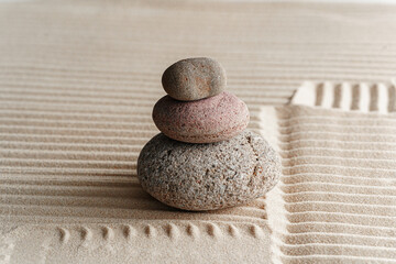 Fototapeta na wymiar Stones on sand, japanese meditation zen garden