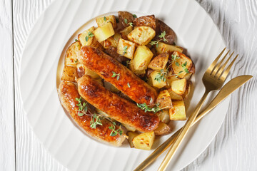 bangers and roasted potatoes on a plate