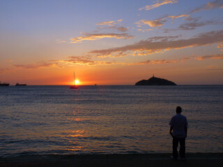 Fototapeta premium Sunset, silhouette, island and clouds, Santa Marta, Columbia