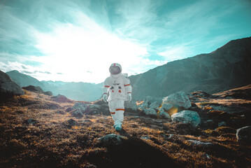 Astronaut exploring a new planet. Searching for a new home for humanity. Concept about science and...