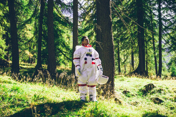 Naklejka na ściany i meble Astronaut exploring a new planet. Searching for a new home for humanity. Concept about science and nature