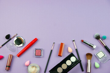 lots of makeup on a purple background with space for writing