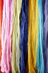 Multicolored samples of gauze in an upright position. Gauze texture and background.