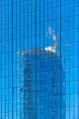 Reflection of construction work and crane in a building