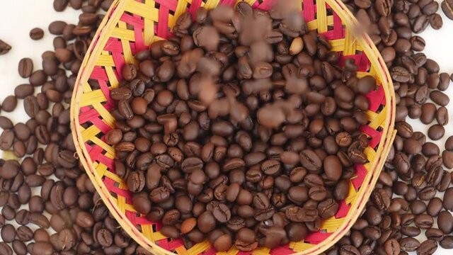 Close view of dropping coffee beans in a bowl