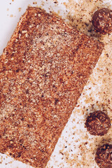 Cake with honey and raspberries on a white plate and brown background. 