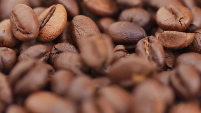 Close shot of coffee beans, View of dropping brown coffee seeds