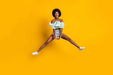 Full length body size photo of jumping careless crazy girl wearing summer clothes isolated on vivid...