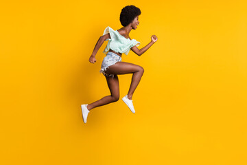 Full length body size side profile photo of jumping high woman running fast sale shouting isolated on vibrant yellow color background