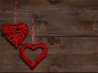 Red shape two handmade hearts on an old vintage wooden brown background. Happy Valentines Day background. Love concept. Top view. Copyspace for text. Banner.