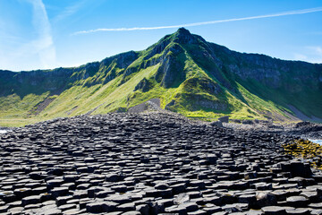 Landscape of Giant's Causeway trail with a blue sky in summer in Northern Ireland, County Antrim....
