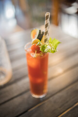 Bloody Mary Cocktail served in bar, garnished with lime, celery and tomato