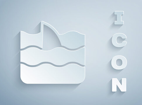 Paper cut Shark fin in ocean wave icon isolated on grey background. Paper art style. Vector.