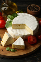 Concept of tasty eating with camembert and spices on wooden background