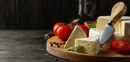 Concept of tasty eating with camembert and spices on wooden background