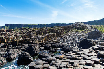 Landscape of Giant's Causeway trail with a blue sky in summer in Northern Ireland, County Antrim....