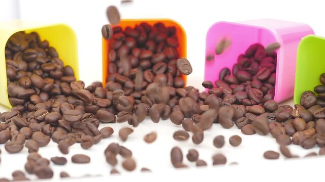 Close shot of falling coffee seeds with plastic bowls around
