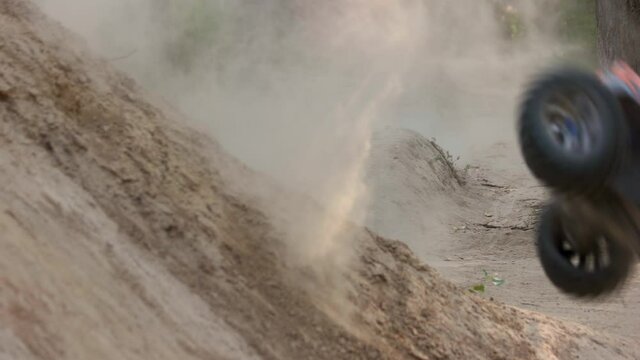 RC buggy car driving on offroad race with obstacles. Radio controlled car on bumpy sandy road.