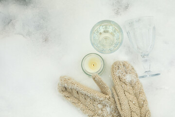 Cozy concept with glasses, candle and mittens  outdoor in winter
