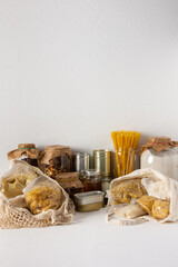 Necessary food for the period of quarantine and isolation, the concept of staying at home, canned food and bags of cereals, various pasta and flour, sugar and honey and coffee