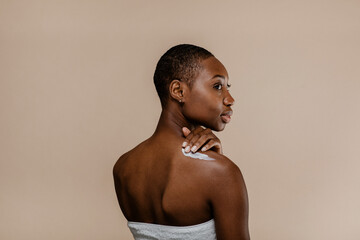 Black woman applying body cream
