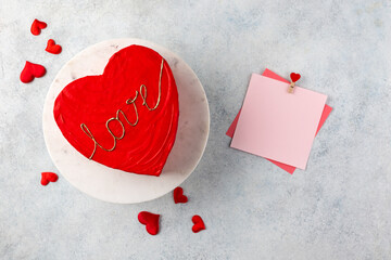 Heart cake for St. Valentine's Day, Mother's Day, or Birthday on cake stand. Light blue background.