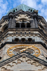 Tower and watch of the Kaiser Wilhelm Gedaechtniskirche at the center of Kurfuerstendamm in West Berlin, Germany, a memorial of World War 2