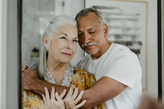 Elderly couple in front of a mirror - Powered by Adobe