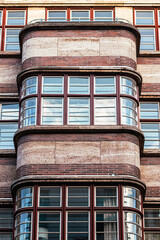 Bay windows and facade, architecture of the 50s and 60s with bricks, typical retro look, rounded shape