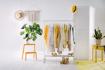 Dressing room interior with clothing rack and houseplants