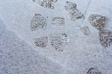 Lots of footprints in snow. danger walking in the snow. Many footprints in the winter ground. Shoe marks outdoor