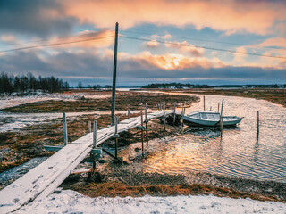 Low tide. Fishing pier in the authentic Northern village of Umba. Kola Peninsula, Russia.