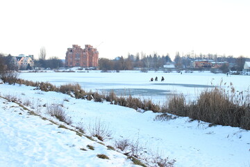 The big lake froze over in winter. Trees are visible in the distance on the shore. The temple is being built on the shore of the lake