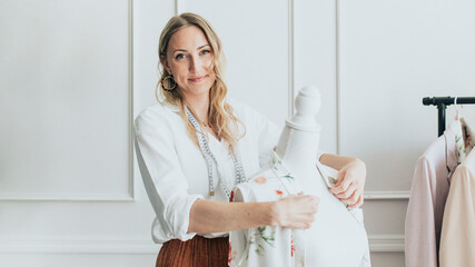 Fashion designer using a pinnable mannequin